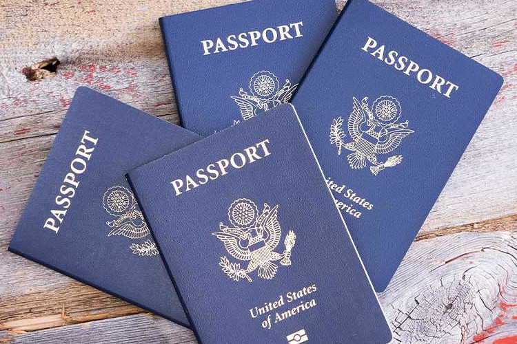 Photo of four passports on a table all at an angle