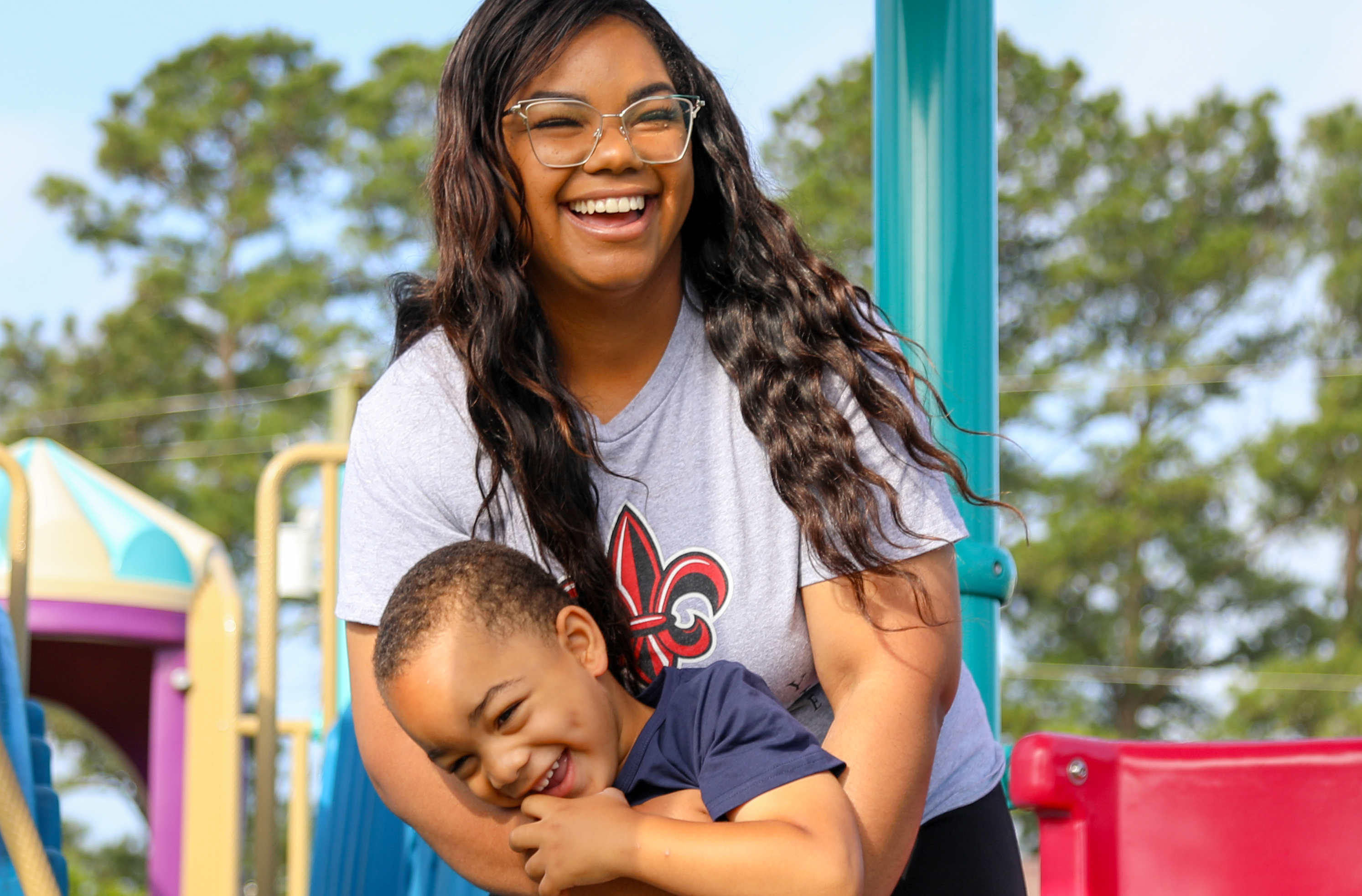 Bre Adams plays with her son in a local park. Bre earned her Bachelor of General Studies online from UL Lafayette.