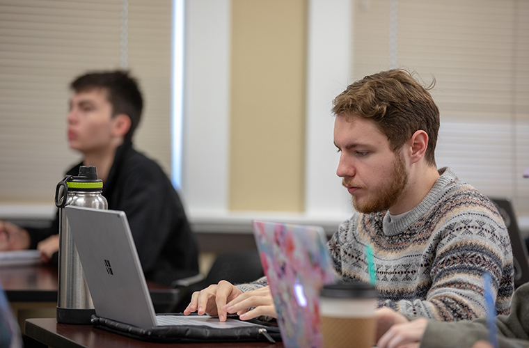 UL Lafayette students in classroom at laptop