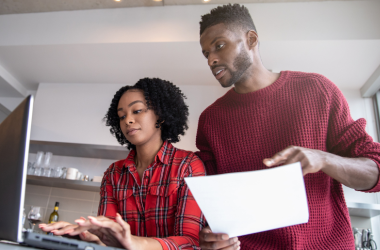 A man and a woman filling out web forms 