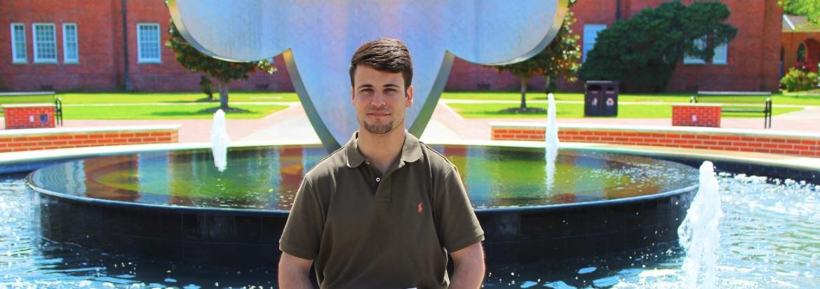 Logan Marks in front of Fleur De Lis fountain