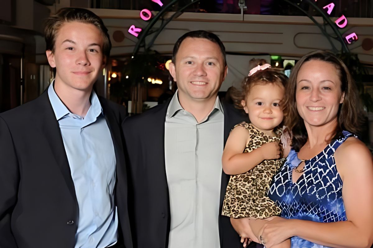 Ellen Farrar, graduate of the Instructional Coaching Graduate Certificate program, poses for a family photo with her husband, daughter, and son.