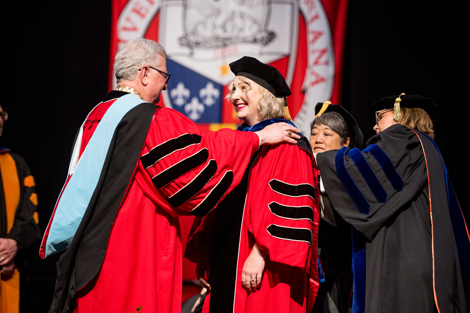 Dr. Savoie hooding a Ph.D. grad on stage