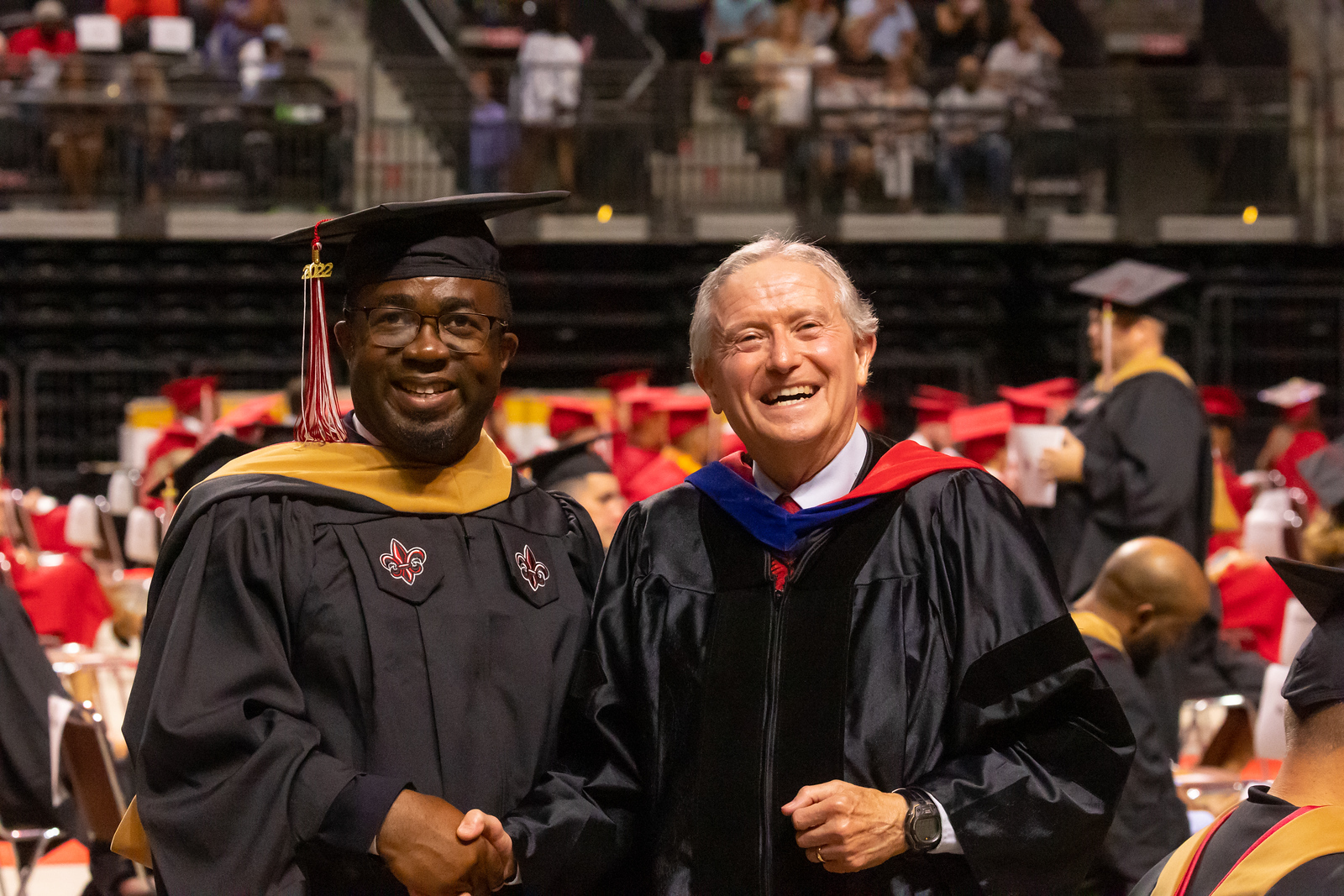 Dr Viguerie shaking hands with a master's graduate