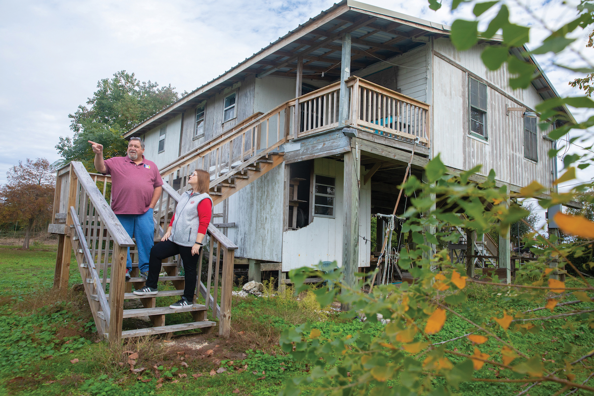 Deme Naquin, Jean Charles Choctaw Nation tribal chief, talks to Dr. Heather Stone at an abandoned house on Isle de Jean Charles.