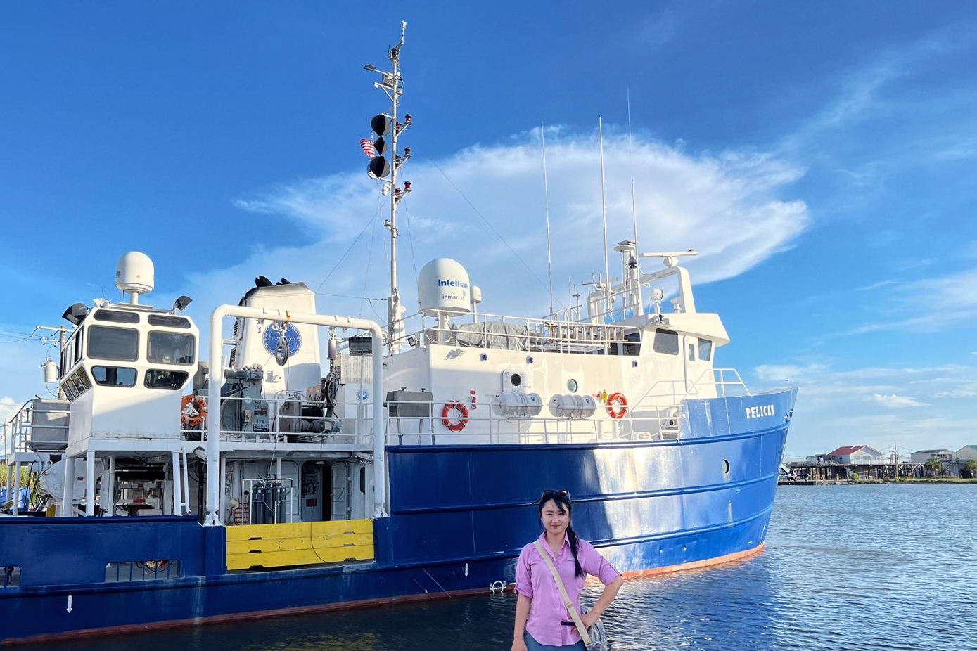 Dr. Liu in front of boat