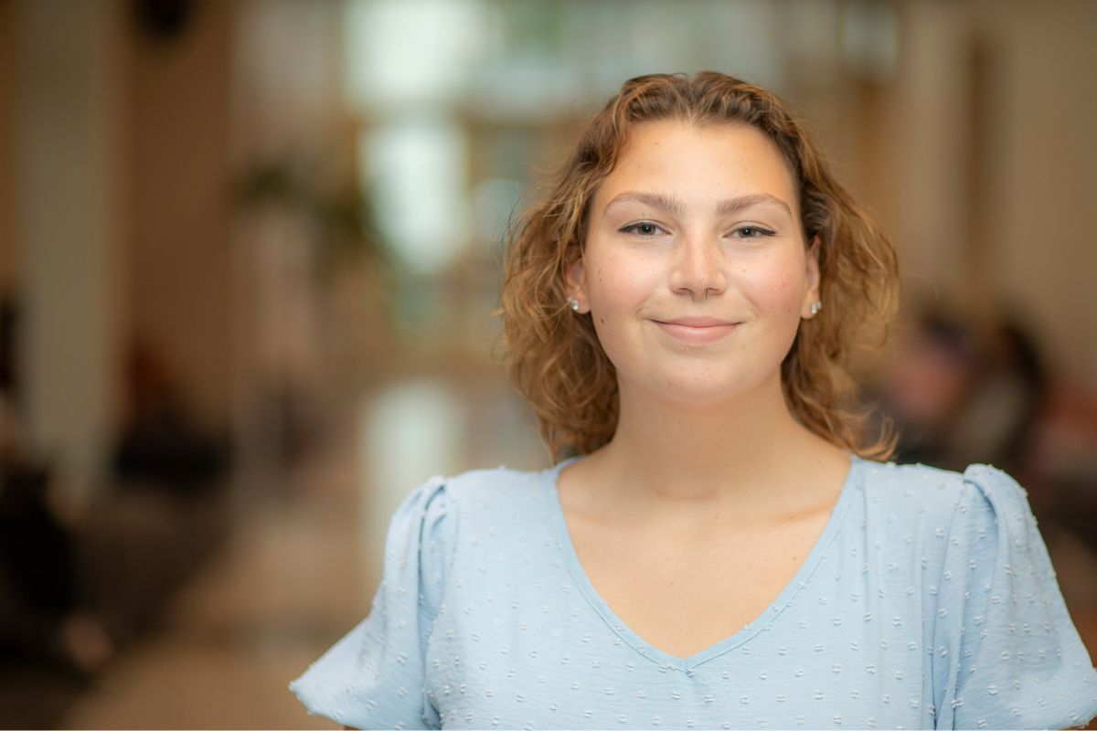 Heaven Rodrigue, wearing a light blue blouse, smiles for a picture. Heaven earned her bachelor's degree in criminal justice from UL Lafayette.