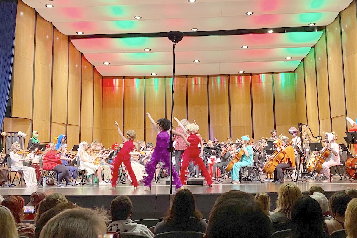 Orchestra members perform in costume, along with dancers, at the annual Halloween concert.