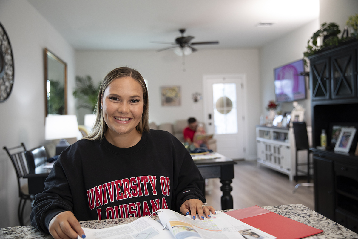 Student sits behind kitchen table