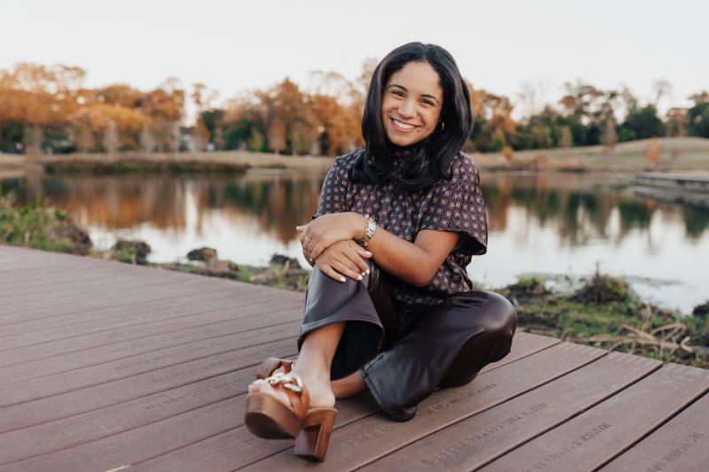 Horizontal professional photo of Kristen Deville in front of a lake.