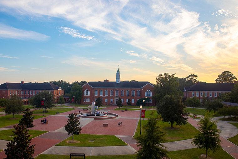 An overhead view of the University of Louisiana at Lafayette Quad with the fleur de lis fountain and Stephens Hall at sunset