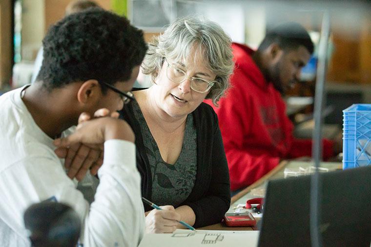 A University of Louisiana at Lafayette professor works with a student in class