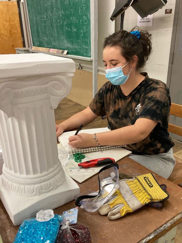 Caroline Stearns works on an art piece in her education classroom