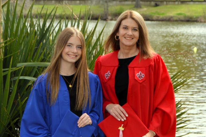 Karen Williams, HSA online graduate, poses with daughter in their caps and gowns.