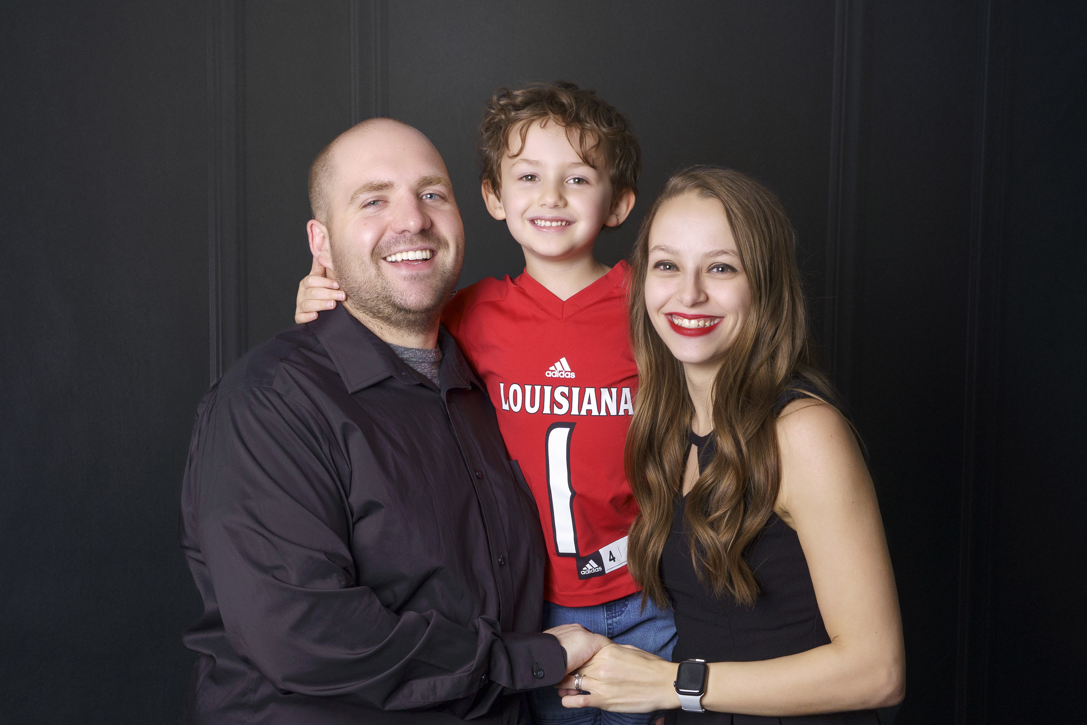 Graduate Hannah Brasseaux, right, with her son Jett and her husband Tylere.