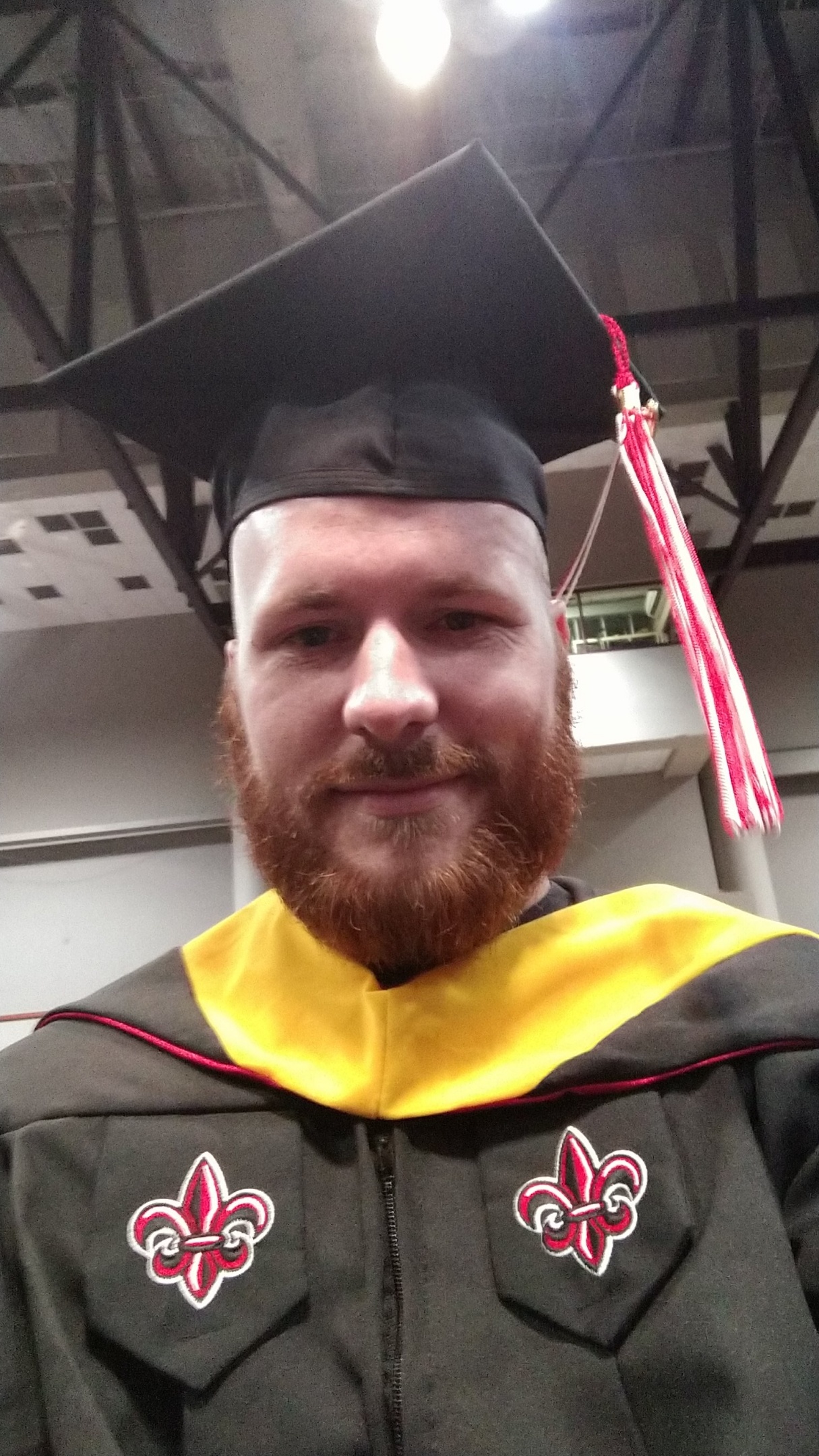 Jason Suire in his cap and gown during commencement in 2019 when he earned his M.S. in Informatics