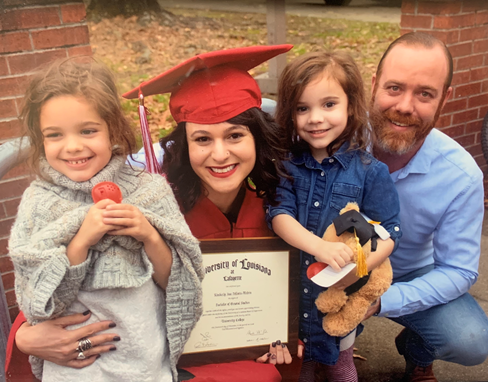 Kimberly Melvin is pictured with her husband and two daughters after completing the online bachelor of general studies program.