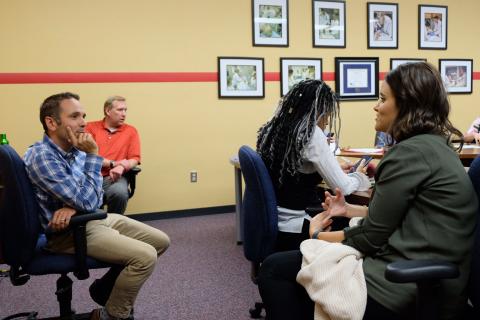 Dr. Roger Rholdon speaks with a DNP student during the online program's two-day intensive