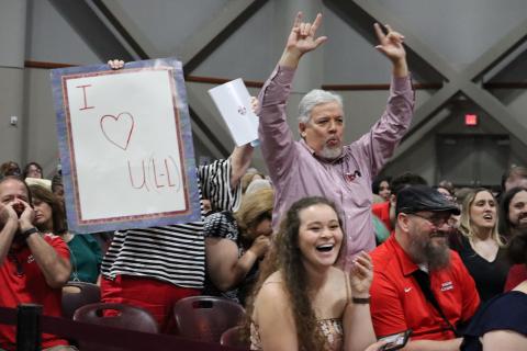 Melanie Fontenot's husband cheers her on during commencement, Spring 2022.