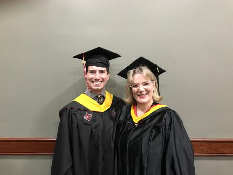 Keith Cangelosi stands with instructor Corinne Dupuy during graduation from UL Lafayette's Systems Technology graduate program.