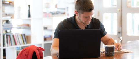 Online student works in a Lafayette coffee shop. UL Lafayette offers online bachelor's, master's and doctoral degrees.