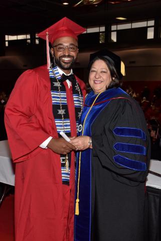 William Davis poses with Dr. Bobbie Decuir during a 2018 commencement ceremony.